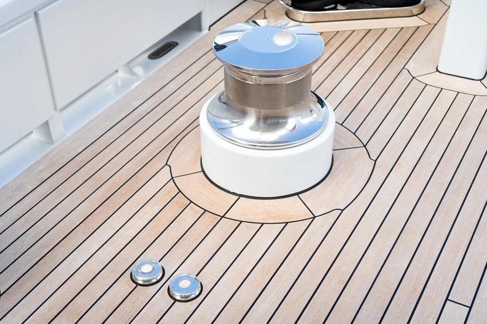 Quality yacht teak deck with metal deck bollard.