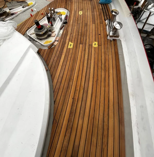 Teak deck on motor yacht partially laid on the yacht.